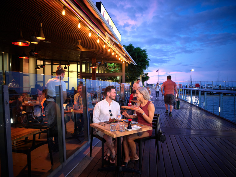 A couple enjoying a meal on the Cairns boardwalk
